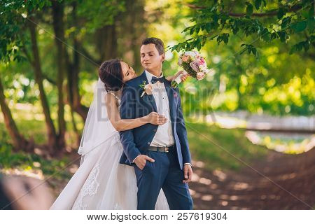 Romantic Wedding Moment, Couple Of Newlyweds Smiling Portrait, Bride And Groom Hug While On A Walk I