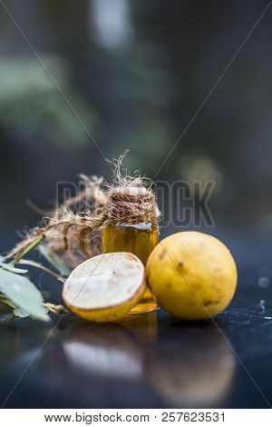Close Up Of Floral And Herbal Essence Of Lemon Or Limbo Or Citrus × Limon In A Transparent Bottle Wi