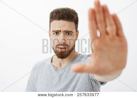 Concerned And Worried Handsome Young Male Friend With Blue Eyes, Beard And Moustache Pulling Palm To