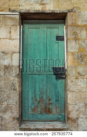 Old wodeen door and stone wall
