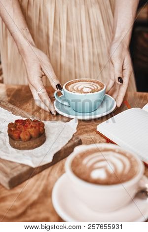 Cup Of Coffee Latte And Sweet Pastry On Wooden Table In Woman Hands. Gentle Romantic Mood, Girl Wear