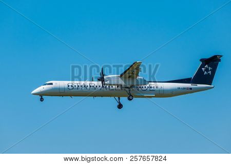 Zurich, Switzerland - July 19, 2018: Star alliance airlines Bomardier Dash 8 Q400 airplane preparing for landing at day time in international airport