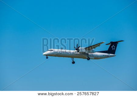 Zurich, Switzerland - July 19, 2018: Star alliance airlines Bomardier Dash 8 Q400 airplane preparing for landing at day time in international airport