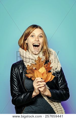 Woman With Autumn Leaves In Leather Jacket. Happy Model With Stylish Hair In Scarf. Beauty And Fashi
