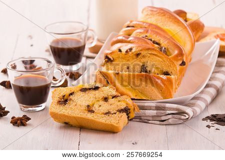 Brioche With Chocolate Chips With Jam On White Dish.