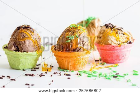 Small Messy Icecream Cups  With Sprinkles And Syrup Drizzled Over On White Background -  Child Birth