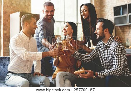 Spending Great Time With Best Friends. Group Of Cheerful Young People Enjoying Food And Drinks While