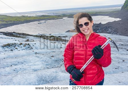 Young Woman With An Ice Axe On The Vatnajokull Glacier  Blue Ice Tour, Iceland