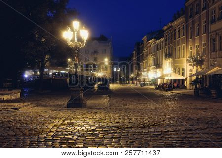 Old European City Pedestrian Street Night City Lights. Old Architeccture Illuminated Street
