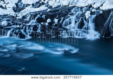 Hraunfossar waterfall in winter, long exposure. One of the most popular waterfall in Iceland, Europe.