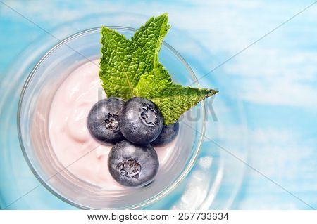 Fresh Bog Whortleberry In Yogurt With Mint Leaves