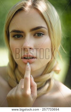Sexy Blond Woman With Finger On Her Lip. Attractive Woman With Her Hair Around Her Nack Posing With 