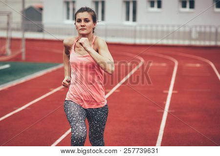 Track Runner Athlete Woman Warming Up Before Running At A Stadium