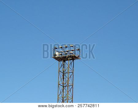 Powerful Illumination System Mounted On High Mast On The Blue Sky Background