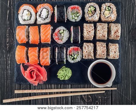 Various Sushi Rolls On Slate. Roll Philadelphia, California And Lollo Ross With Wasabi Ginger And So