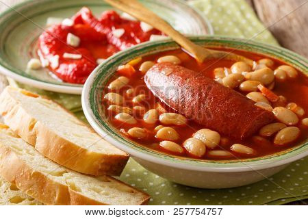 Pasulj (grah) Bean Soup With Sausage Is Served With Bread And Bell Pepper Close-up On A Plate. Horiz