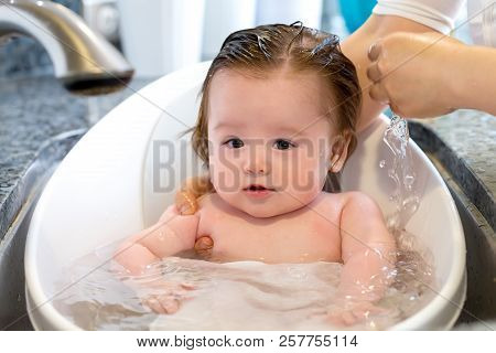 Baby Boy Taking A Bath In A Little Bath Tub