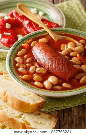 Bean Soup With Sausage Served With Pickled Pepper And Garlic Close-up. Vertical