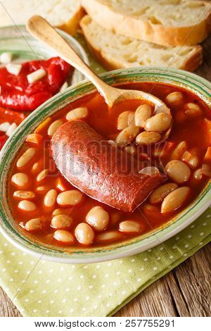 Balkan Food Pasulj Soup With Sausage Served With Pickled Pepper And Garlic Close-up. Vertical