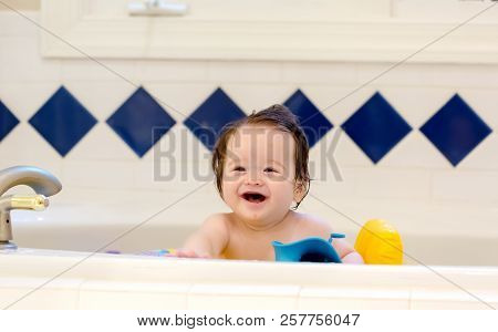 Baby Boy Taking A Bath In A Big Bath Tub