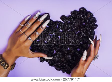 Woman Hands With Long Nails Manicure Holding Fruits In Shape Of