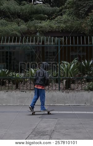 The Lonely Skater Boy In The City On Cloudy Day.
