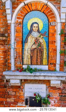 Venice, Italy - September 23, 2018 Street Shrine Nun Saint Mosaic Venice Italy Italian Words Say For