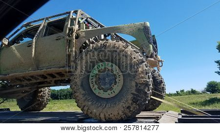 Money Pits 2.0 Off Road Truck Vehicle Truck Covered In Mud Being Towed Down The Highway In Summer, N