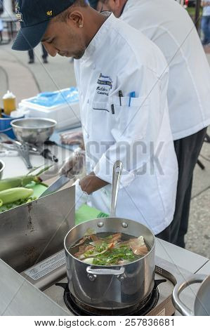 Pot Of Vegetables Beginning To Simmer As Chef Helder Costa Chops Up More Ingredients At The 2018 New