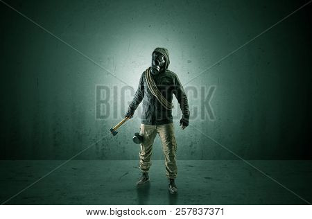 Bad agent in a dark room with arms on his hand and gas mask