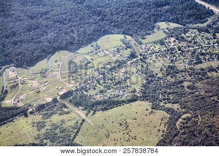 desaturated airview landscape with town and forest