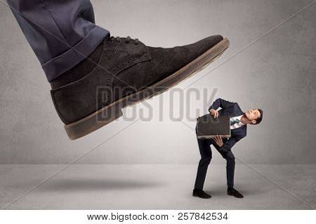 Young businessman illustrated inconsiderable by being trampled