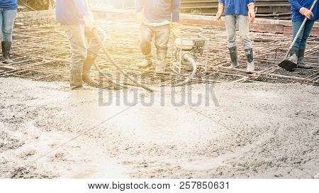 Workers Man Using A Vibration Machine For Eliminate Bubbles In Concrete. After Pouring Ready-mixed C