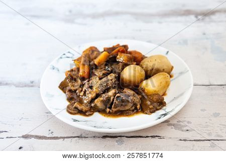 Beef meat stewed with potatoes-Traditional French cuisine Beef Bourguignon potatoes carrots in persillade