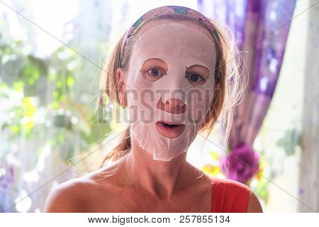 Girl with a cosmetic mask on her face