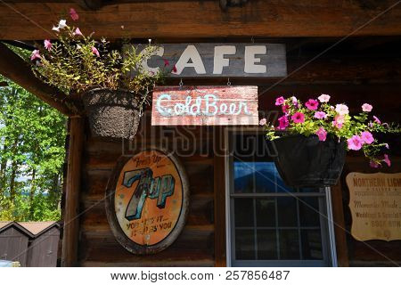 POLEBRIDGE, MONTANA, USA - September 9, 2018: Cafe, Cold Beer and vintage 7Up signs adorn the exterior of the Northern Lights Saloon.