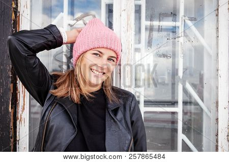 Portrait  Outdoor Atmospheric Lifestyle Photo Of Young Beautiful  Darkhaired Woman  In Knitting Hat,