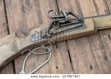 Closeup Of Antique Firearm. Close-up. On Wooden Background.