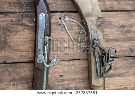 Closeup Of Antique Firearm. Close-up. On Wooden Background.