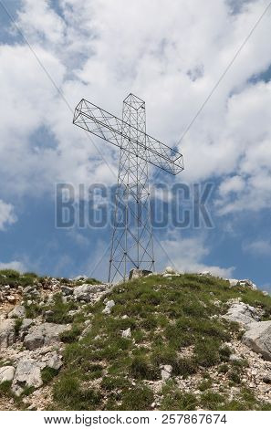 Big Cross On Top Of Mountains And Blue Sky With Clouds