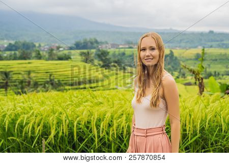 Young Woman Traveler On Beautiful Jatiluwih Rice Terraces Against The Background Of Famous Volcanoes