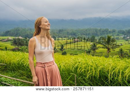 Young Woman Traveler On Beautiful Jatiluwih Rice Terraces Against The Background Of Famous Volcanoes
