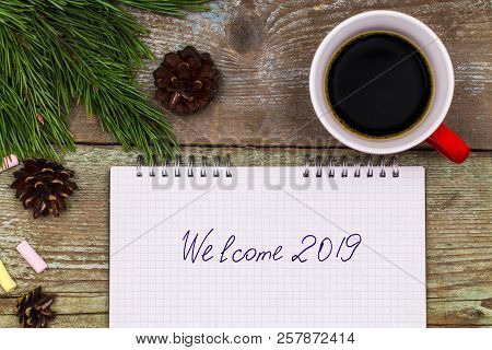 New Year 2019 Concept. Notebook On Wood Table Writing Welcome 2019.