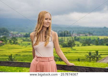 Young Woman Traveler On Beautiful Jatiluwih Rice Terraces Against The Background Of Famous Volcanoes