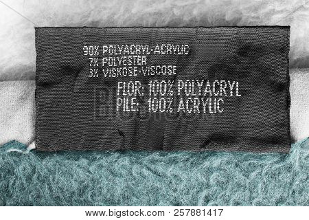 Composition Clothes Label On White And Blue Textile Background Closeup