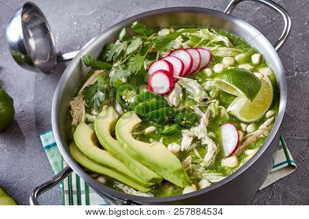 Chicken Pozole Verde In A Pot - Mexican Stew Filled With Shredded Chicken And Hominy In A Warm Green