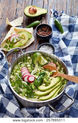 Chicken Pozole Verde In A Pot - Mexican Stew Filled With Shredded Chicken And Hominy In A Warm Green
