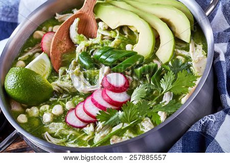 Pozole Verde In A Metal Casserole - Mexican Stew Filled With Shredded Meat And Hominy In A Warm Gree
