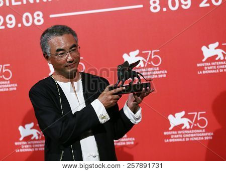 Pema Tseden poses with Orizzonti Award for Best Screenplay Award forJinpa at the Winners Photocall during the 75th Venice Film Festival on September 8, 2018 in Venice, Italy.