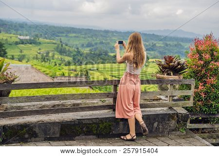 Young Woman Traveler On Beautiful Jatiluwih Rice Terraces Against The Background Of Famous Volcanoes